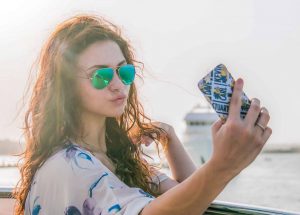 Teenage girl taking a selfie. Identify and protect yourself from narcissistic personality disorder