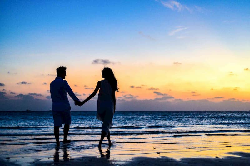 Couple holding hands on beach